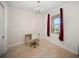 Bright bedroom featuring a chandelier, wood floors, a desk and a window with burgundy drapes at 525 N Orange Ave # 302, Sarasota, FL 34236