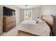 Bedroom showcasing natural light from the window, wooden bed frame and a dresser with television at 525 N Orange Ave # 302, Sarasota, FL 34236