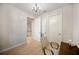 Bright bedroom with wood floors and white doors, and a view of the kitchen through a doorway at 525 N Orange Ave # 302, Sarasota, FL 34236