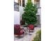 Courtyard featuring a large tree, brick pavers, and red cushioned seating at 525 N Orange Ave # 302, Sarasota, FL 34236