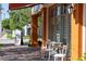 Exterior view of a building with outdoor seating, featuring neutral color columns and accents at 525 N Orange Ave # 302, Sarasota, FL 34236
