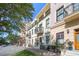 A row of townhouses on a city street feature wrought iron balconies and lush landscaping at 525 N Orange Ave # 302, Sarasota, FL 34236