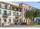 Exterior view of townhouses with multiple balconies and pastel colored facades on a sunny day at 525 N Orange Ave # 302, Sarasota, FL 34236