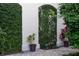 Exterior wall covered in greenery, adjacent to a brick paver patio at 525 N Orange Ave # 302, Sarasota, FL 34236