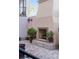 Outdoor fireplace with planters, on a patio of brick pavers, with neutral colored walls at 525 N Orange Ave # 302, Sarasota, FL 34236