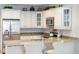 Eat at the bar in this kitchen with white cabinets, granite countertops, and stainless steel appliances at 525 N Orange Ave # 302, Sarasota, FL 34236