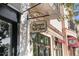 Exterior view of 'Rosemary & Thyme' sign with ornate bracket against a beautiful stone facade with inviting storefront windows at 525 N Orange Ave # 302, Sarasota, FL 34236