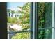 Framed by a window, a lush tree with bright pink flowers sits outside at 525 N Orange Ave # 302, Sarasota, FL 34236