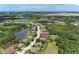 Gorgeous aerial view of a tranquil community surrounded by lush greenery and serene lakes and clear blue skies at 5359 90Th Avenue E Cir, Parrish, FL 34219