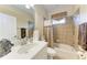 A cozy bathroom with a vanity, a toilet, and a shower-tub combo featuring tile walls and stylish fixtures at 5359 90Th Avenue E Cir, Parrish, FL 34219
