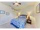Bright bedroom featuring a comfortable bed with stylish blue patterns, complementing wall decorations, and neutral-toned walls at 5359 90Th Avenue E Cir, Parrish, FL 34219