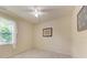 This bedroom features a ceiling fan and a window with a view of the backyard at 5359 90Th Avenue E Cir, Parrish, FL 34219