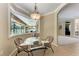 Cozy dining area with a glass table and four chairs, filled with natural light at 5359 90Th Avenue E Cir, Parrish, FL 34219