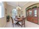 Traditional dining room with wood table, chairs, and china cabinet, illuminated by an elegant chandelier at 5359 90Th Avenue E Cir, Parrish, FL 34219