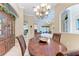 Open-concept dining area with wood table and chairs, seamlessly flowing into the living room at 5359 90Th Avenue E Cir, Parrish, FL 34219