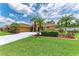 Charming single-story home featuring a well-manicured lawn and lush tropical landscaping at 5359 90Th Avenue E Cir, Parrish, FL 34219