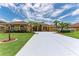 Inviting exterior view of a house with a well-manicured lawn, landscaping, and an extended driveway at 5359 90Th Avenue E Cir, Parrish, FL 34219