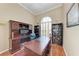 Dedicated home office with built-in desk, shelving, hardwood floors, and natural light at 5359 90Th Avenue E Cir, Parrish, FL 34219
