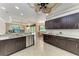 Gourmet kitchen with dark cabinetry, granite countertops, and stainless steel appliances at 5359 90Th Avenue E Cir, Parrish, FL 34219