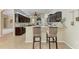 Well-appointed kitchen with a breakfast bar, granite countertops, and dark wood cabinetry at 5359 90Th Avenue E Cir, Parrish, FL 34219