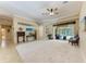 Spacious living room featuring neutral paint, tiled floors, and sliding glass doors to the outdoor living space at 5359 90Th Avenue E Cir, Parrish, FL 34219