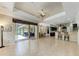 Open-concept living room with tile flooring, ceiling fan, and seamless access to the outdoor living area at 5359 90Th Avenue E Cir, Parrish, FL 34219