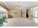 Open-concept living area with tile flooring, neutral walls, tray ceiling, and access to the lanai at 5359 90Th Avenue E Cir, Parrish, FL 34219