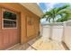 Outdoor shower area with wooden planks and a privacy fence, offering a convenient way to rinse off after a swim at 5359 90Th Avenue E Cir, Parrish, FL 34219