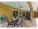 A covered patio with an outdoor dining area and an adjoining seating area with comfortable furniture at 5359 90Th Avenue E Cir, Parrish, FL 34219