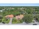 Expansive aerial view of a beautiful home nestled among lush green trees in a tranquil neighborhood at 5584 Eastwind Dr, Sarasota, FL 34233