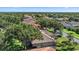 A tile roof home with a spacious backyard is showcased in a lush, tree-filled neighborhood at 5584 Eastwind Dr, Sarasota, FL 34233