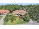 Charming home boasts lush landscaping, a pristine lawn, and a tile roof, offering an inviting curb appeal at 5584 Eastwind Dr, Sarasota, FL 34233