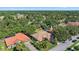 A tile roof home with lush landscaping sits in a quiet, tree-filled neighborhood at 5584 Eastwind Dr, Sarasota, FL 34233