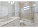 Bright bathroom featuring granite counters, tile floors, soaking tub and glass-enclosed shower at 5584 Eastwind Dr, Sarasota, FL 34233