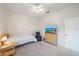 Comfortable bedroom featuring ceiling fan, TV, reading chair and light wood furniture at 5584 Eastwind Dr, Sarasota, FL 34233