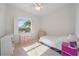 Bright bedroom with a ceiling fan, bright window, and neutral carpet at 5584 Eastwind Dr, Sarasota, FL 34233