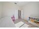 Bright bedroom with neutral carpet, white walls, and a pink bedside table at 5584 Eastwind Dr, Sarasota, FL 34233