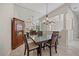 Dining room with decorative mirror, chandelier, and hardwood furniture at 5584 Eastwind Dr, Sarasota, FL 34233