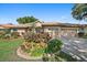 Charming single-story home with a well-manicured lawn and vibrant landscaping at 5584 Eastwind Dr, Sarasota, FL 34233