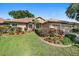Beautiful home showcasing meticulously maintained landscaping and a well manicured lawn at 5584 Eastwind Dr, Sarasota, FL 34233