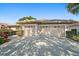 Exterior front view of a home with a two-car garage and well-maintained landscaping at 5584 Eastwind Dr, Sarasota, FL 34233