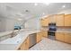 Well-lit kitchen with stainless steel appliances, granite countertops, and light wood cabinetry at 5584 Eastwind Dr, Sarasota, FL 34233