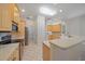 Spacious kitchen featuring stainless steel appliances, granite countertops, and light wood cabinetry at 5584 Eastwind Dr, Sarasota, FL 34233