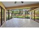 Screened lanai featuring a tile floor and view of the green backyard at 5584 Eastwind Dr, Sarasota, FL 34233