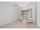Light and airy living space with tile floors, sliders to the back, and comfortable seating at 5584 Eastwind Dr, Sarasota, FL 34233