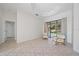 Sitting area features tile flooring, a ceiling detail, and sliding glass doors to the backyard at 5584 Eastwind Dr, Sarasota, FL 34233