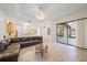Open-concept living room with tile flooring, ceiling fan, and views into the kitchen at 5584 Eastwind Dr, Sarasota, FL 34233