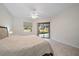 Bright main bedroom with neutral tones and a sliding glass door leading to the lanai at 5584 Eastwind Dr, Sarasota, FL 34233