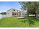 Expansive backyard with screened-in pool, patio, lush lawn, and a white privacy fence at 5981 Willows Bridge Loop, Ellenton, FL 34222