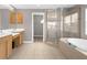 Main bathroom featuring dual vanities, glass shower, and soaking tub at 5981 Willows Bridge Loop, Ellenton, FL 34222